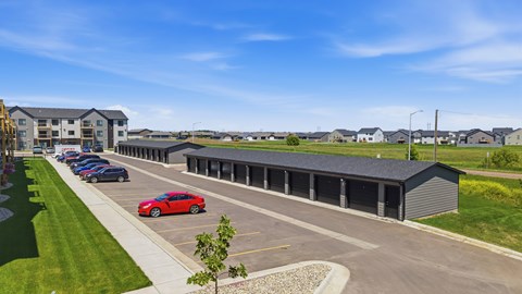 A parking lot with cars and a building in the background.