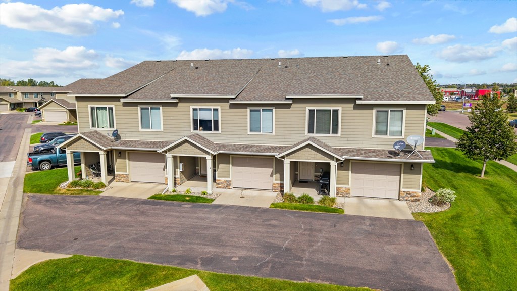 A house with a grey roof and a grey garage door.