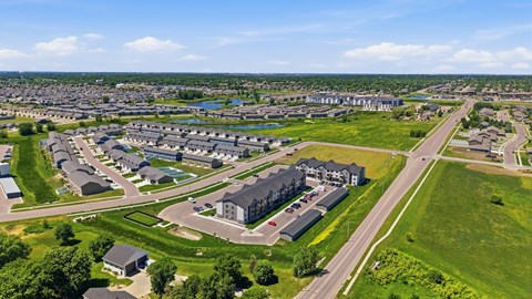 A bird's eye view of a residential area with houses and green spaces.