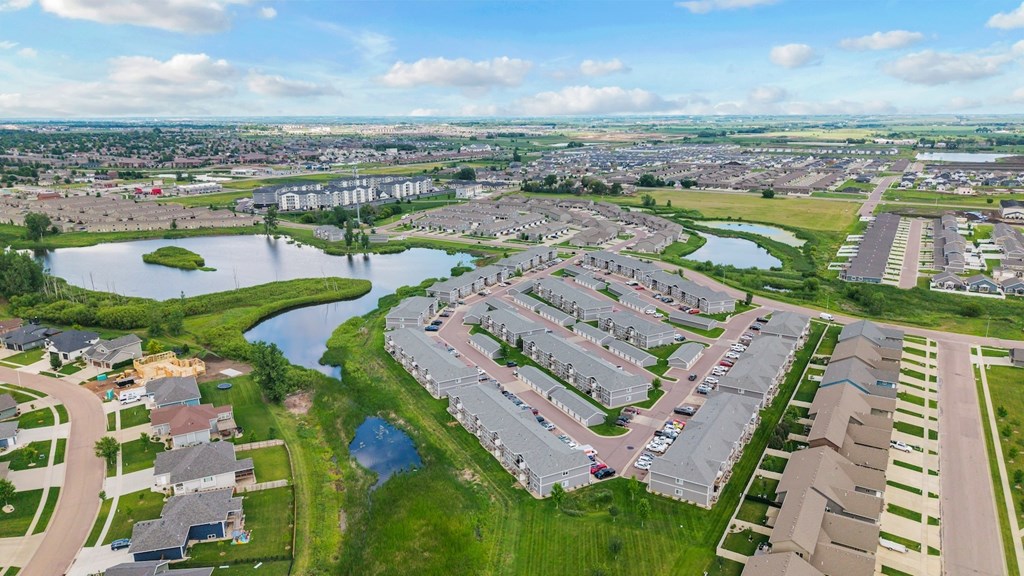 A bird's eye view of a residential area with houses and a river.