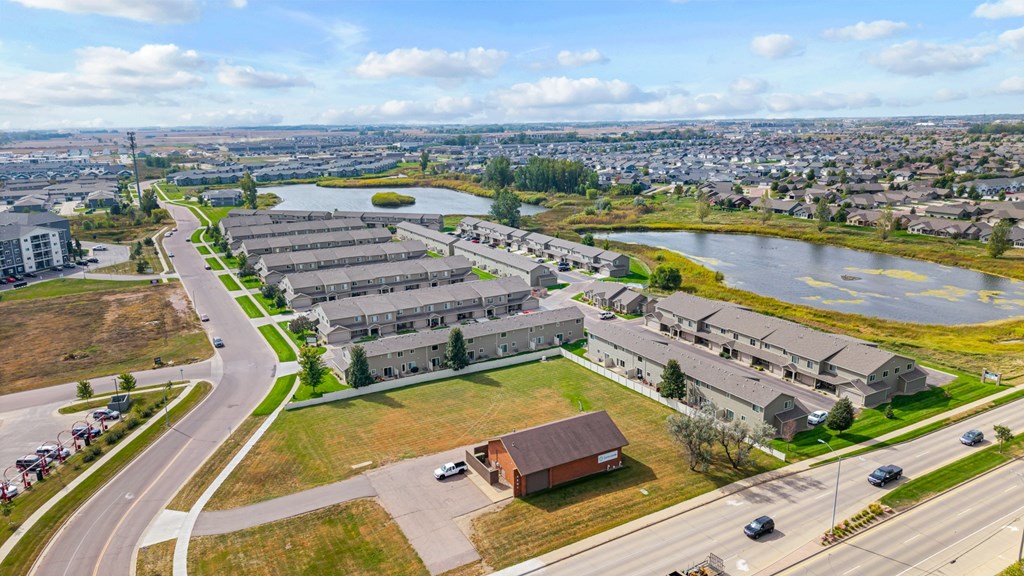 A large building complex is situated next to a body of water.
