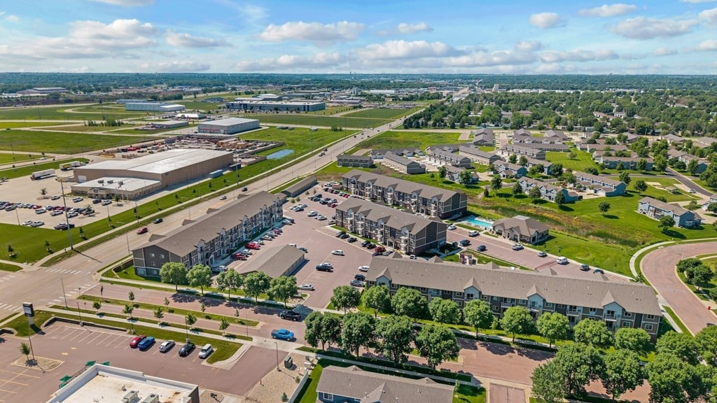A large aerial view of a city with a mix of buildings and green spaces.