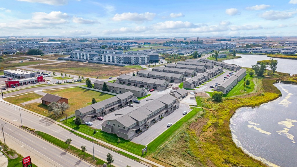 A large building complex is situated next to a body of water.