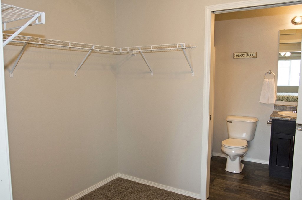 a bathroom with a toilet and a shower and a towel rack