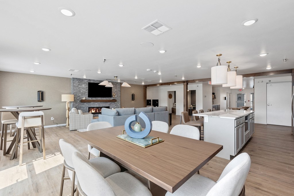 a living room and dining room with a table and chairs