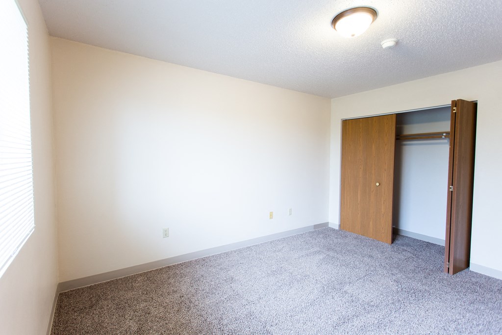 a empty room with a door to a closet