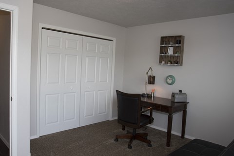 a room with a desk and a door