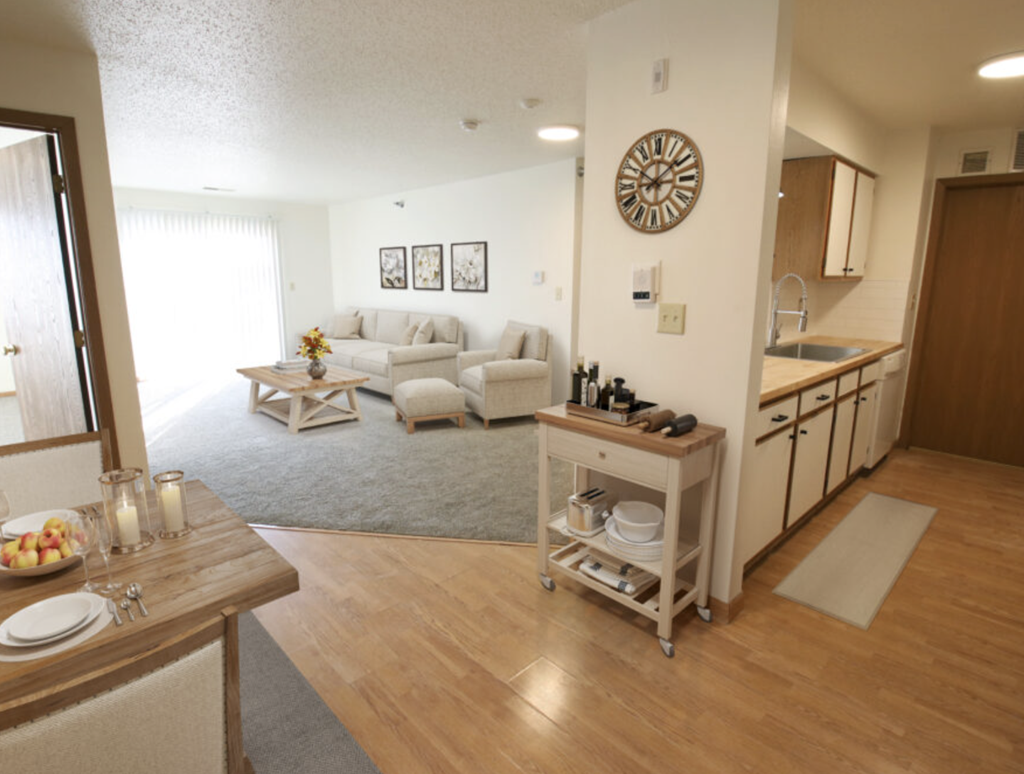 the living room and kitchen of an apartment
