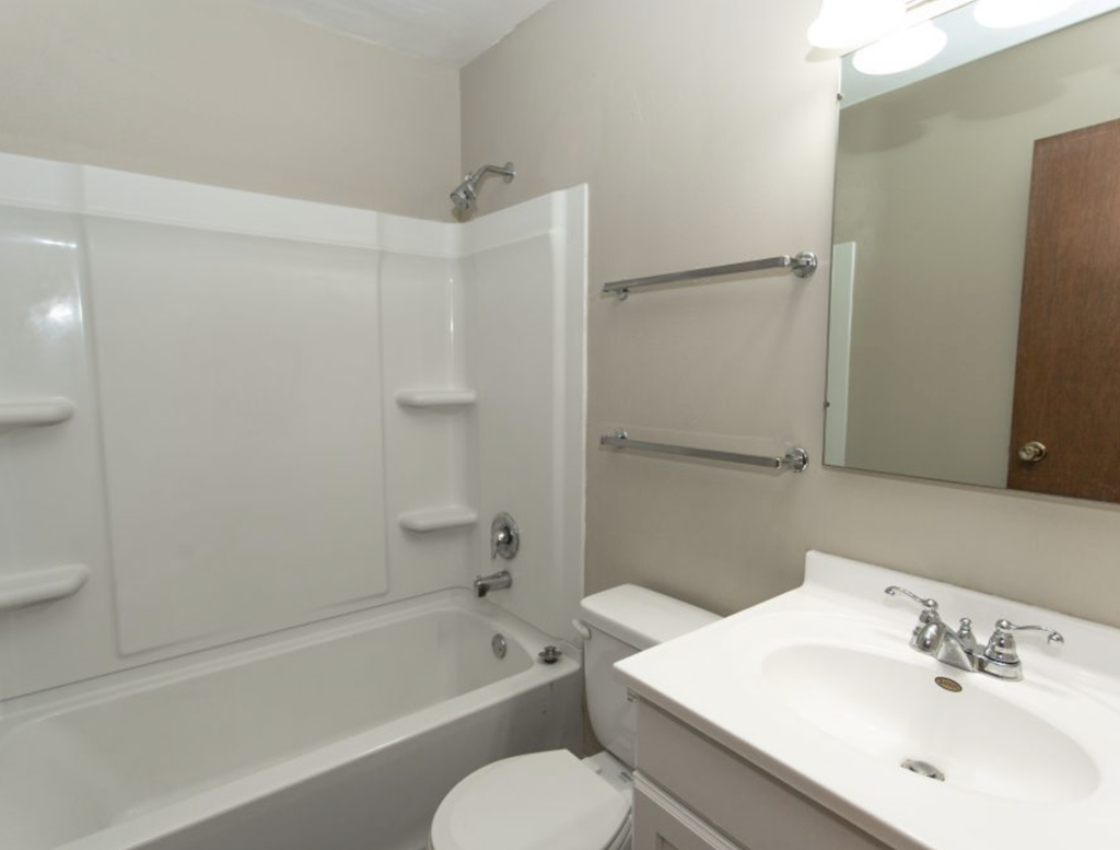 a white bathroom with a sink toilet and bath tub