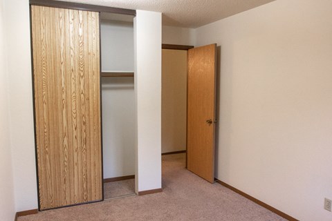 a room with a closet and an open door
