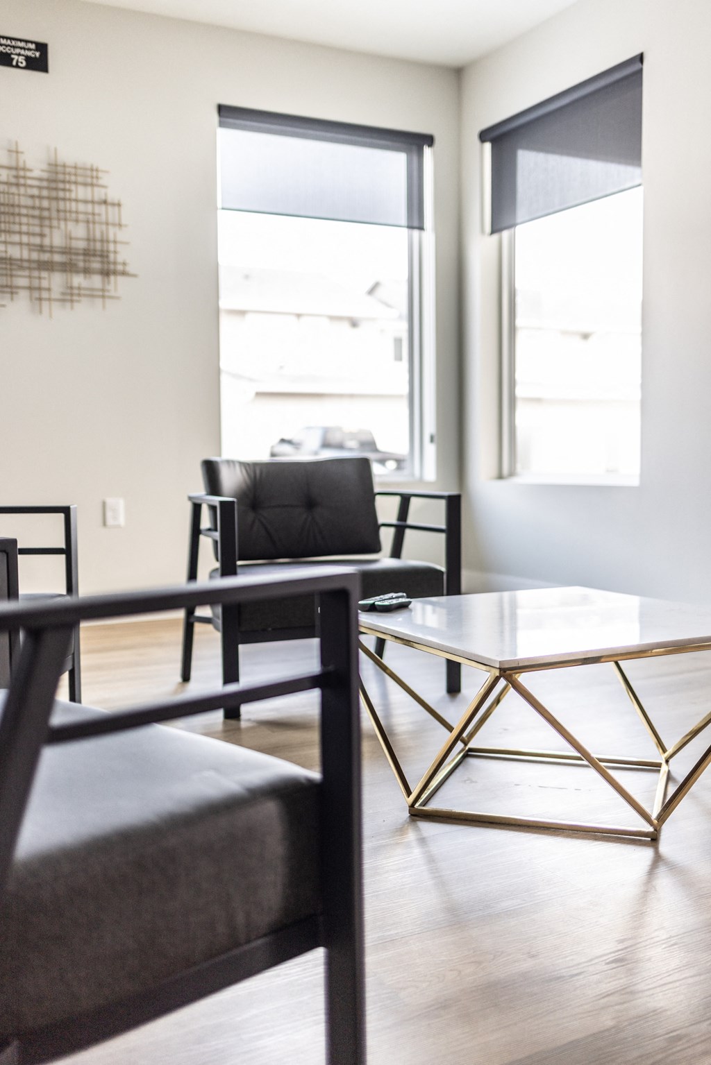 a living room with a table and chairs and a window