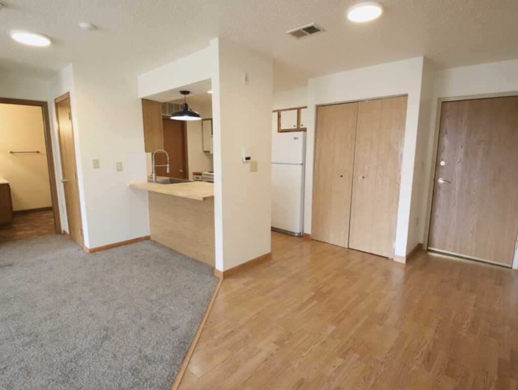 an empty living room and kitchen in a house