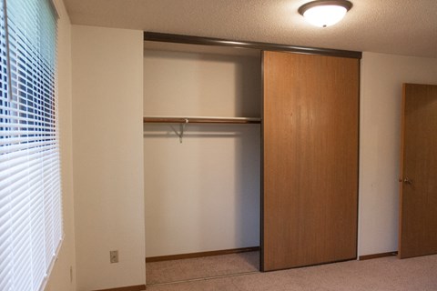 an empty closet in a room with a window