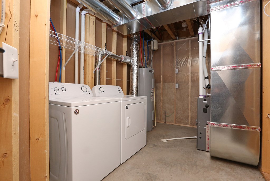 a laundry room with two washers and two dryers in it