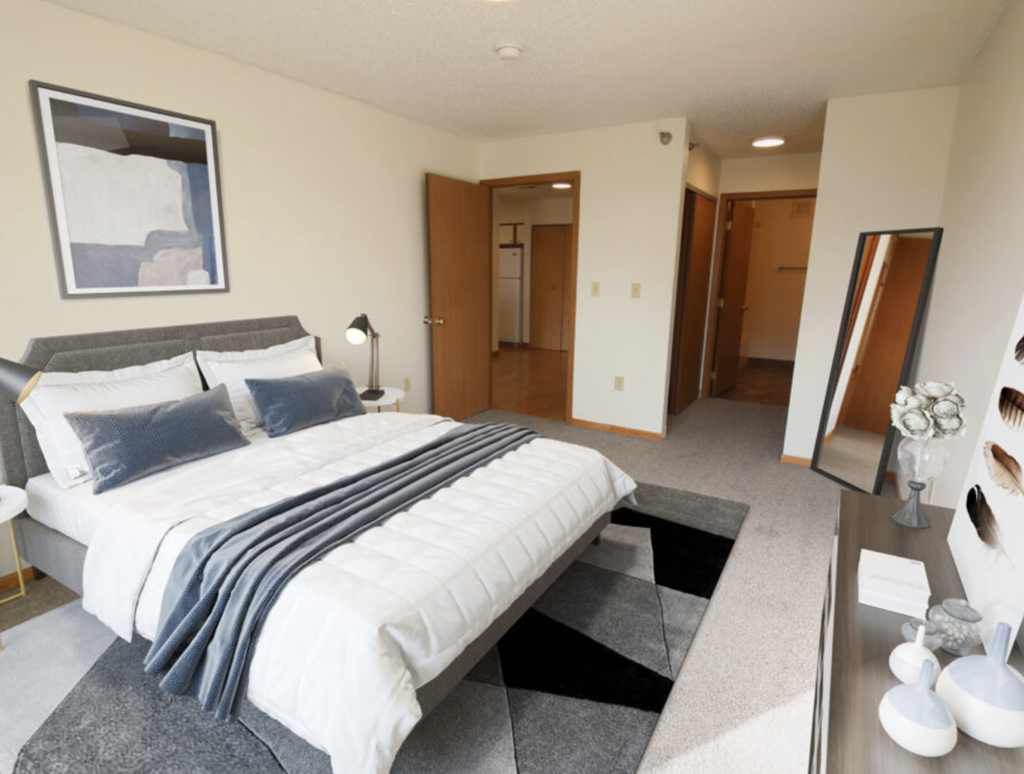 a master bedroom with a large bed and a walk in closet