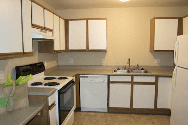 a kitchen with a stove and a sink and a refrigerator