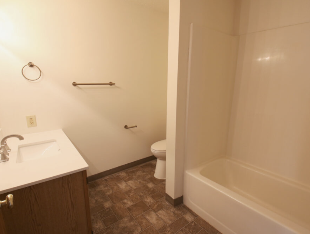 a bathroom with a sink and a toilet and a bath tub