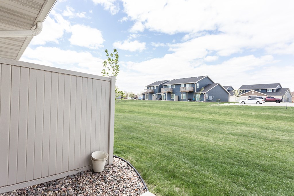 the backyard of a house with a yard and a privacy fence
