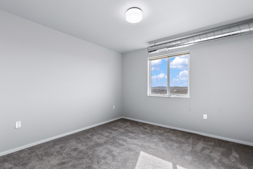 bedroom with exposed duct work