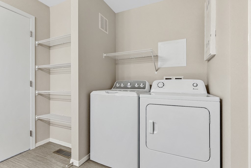 a white washer and dryer in a room next to a closet