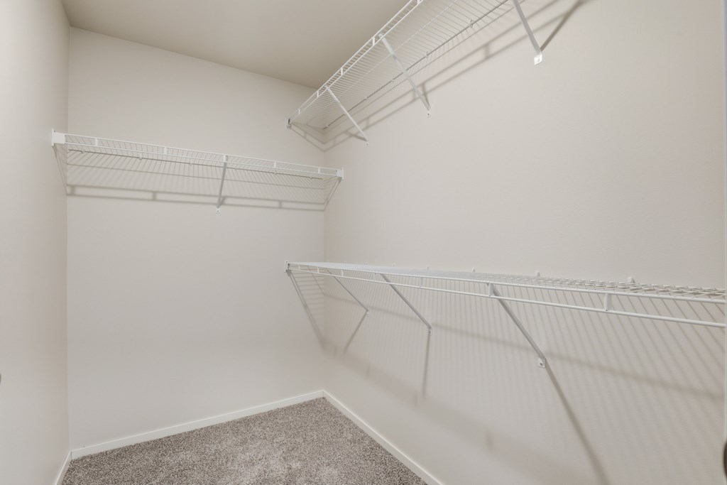 Empty room with white walls and shelves.