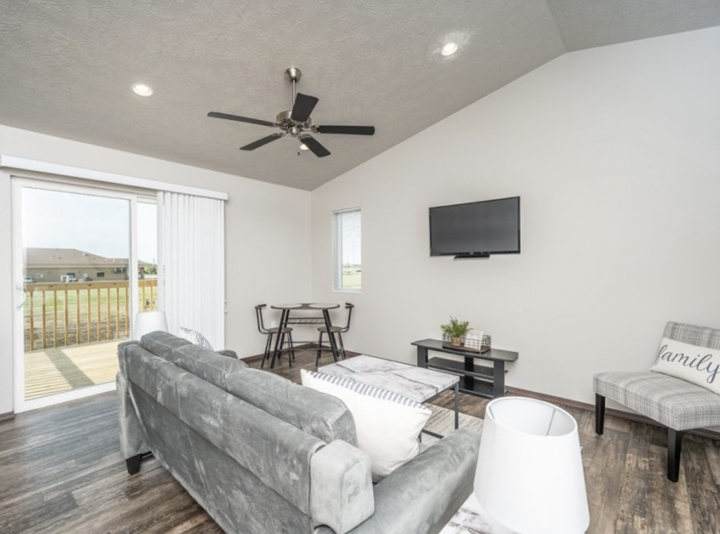 a living room with a couch and a ceiling fan