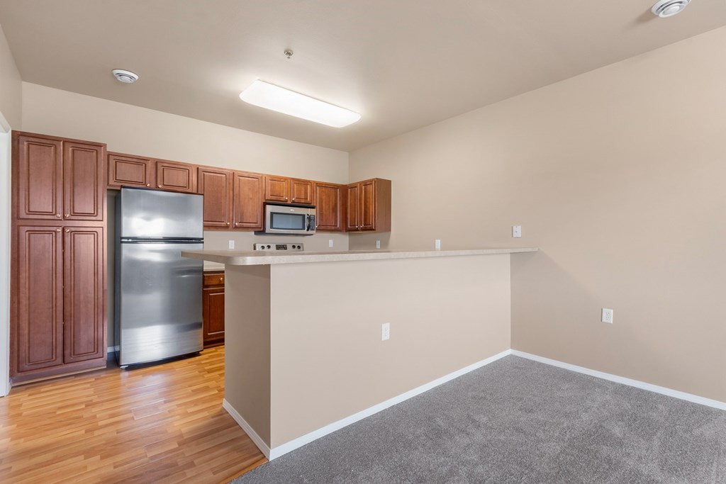 A kitchen with wooden cabinets and stainless steel appliances.