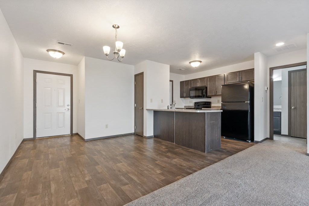 A kitchen area with a refrigerator, microwave, and oven.