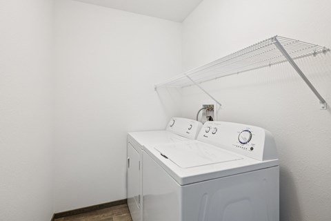 A white washing machine in a laundry room.