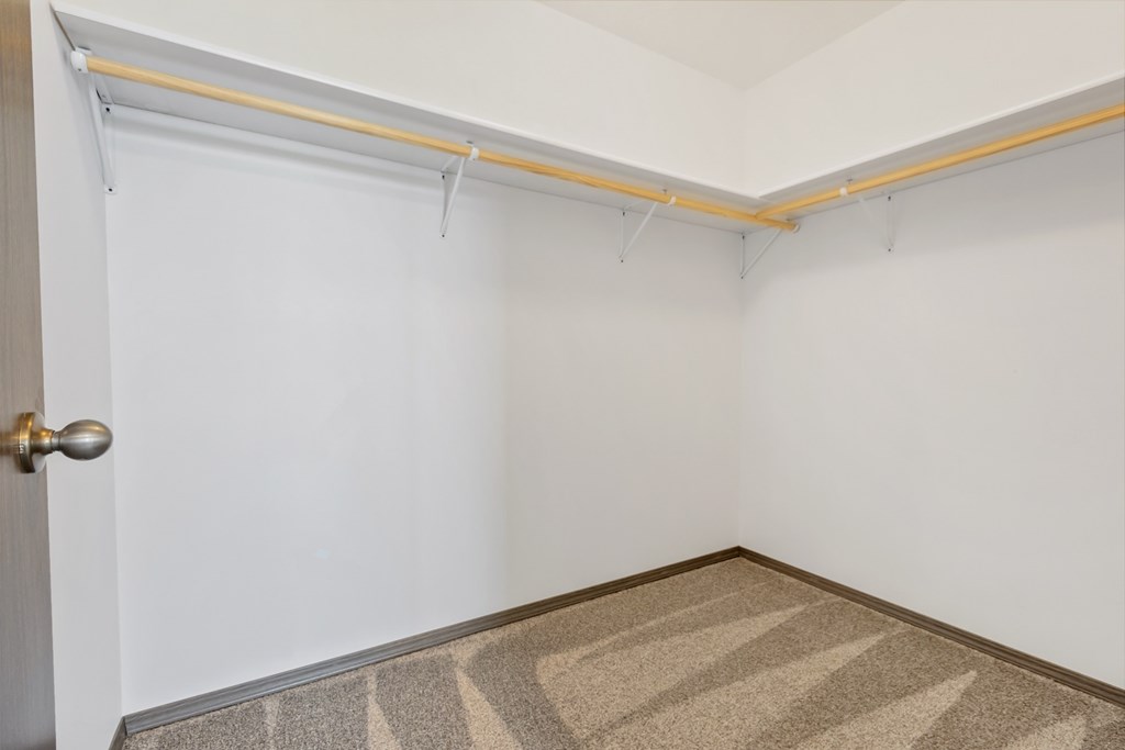 A room with a door and a carpet on the floor.