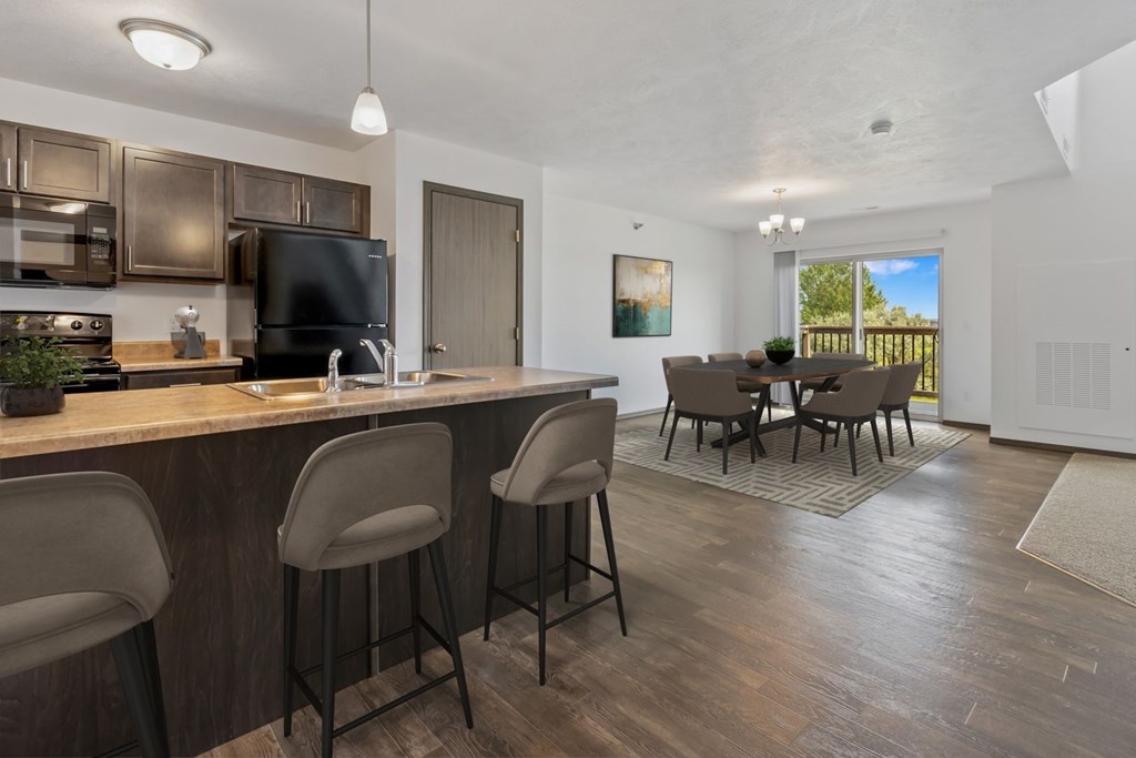 A kitchen with a bar area and a dining table.