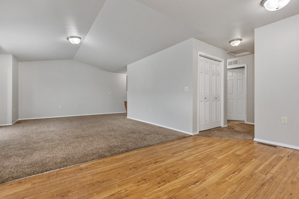 A room with wooden floors and white walls.