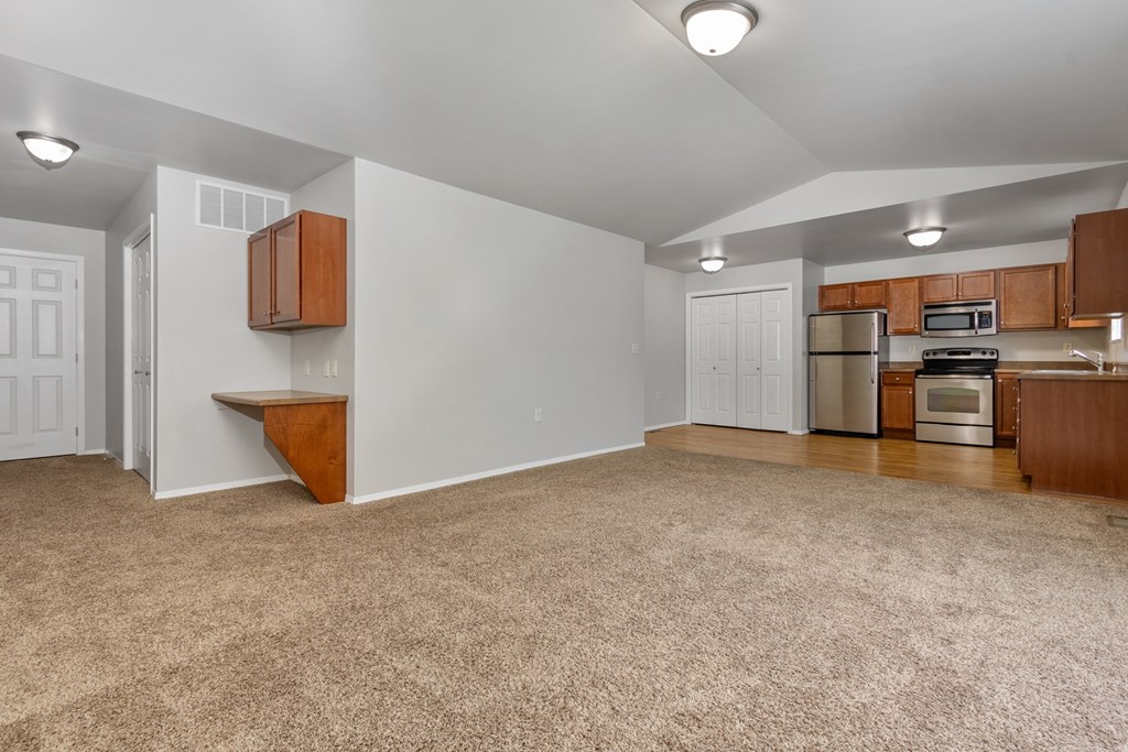 A kitchen area with a refrigerator, microwave, and oven.