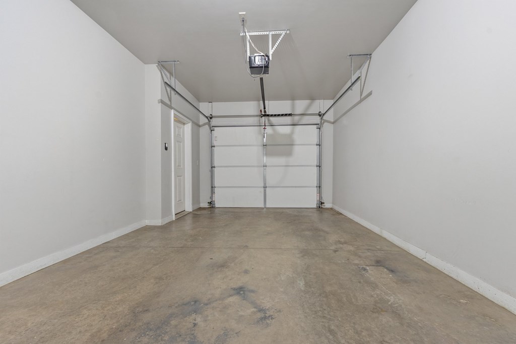 A room with a concrete floor and white walls.