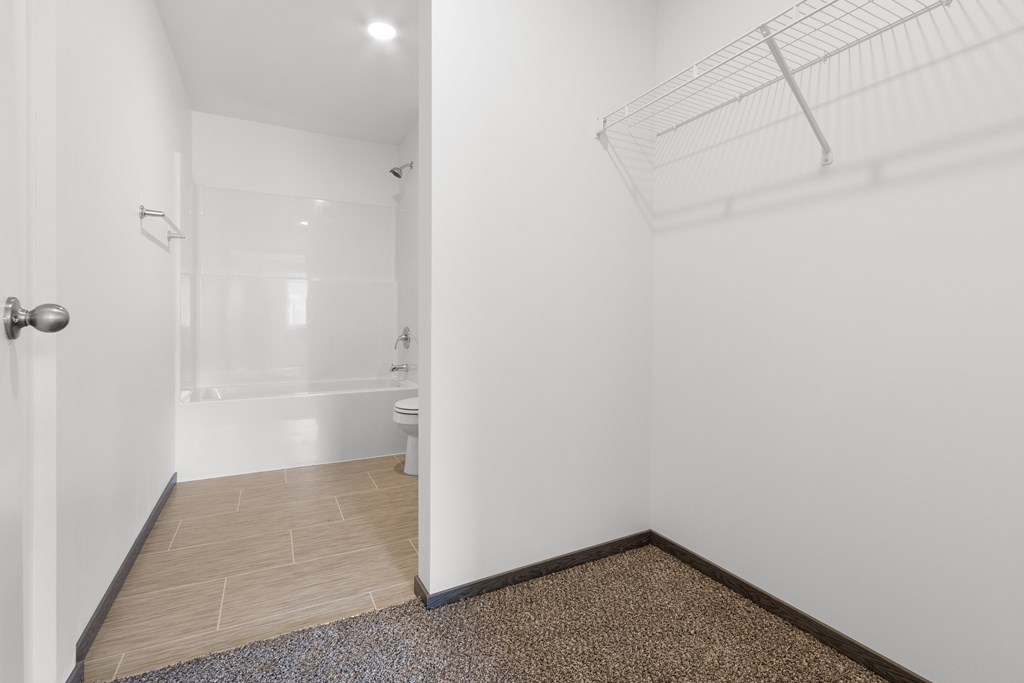 A bathroom with a toilet, sink, and shower.