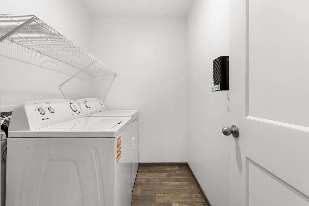 A white washing machine and dryer in a small laundry room.