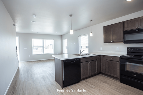 a kitchen with dark wood cabinets and a white counter top