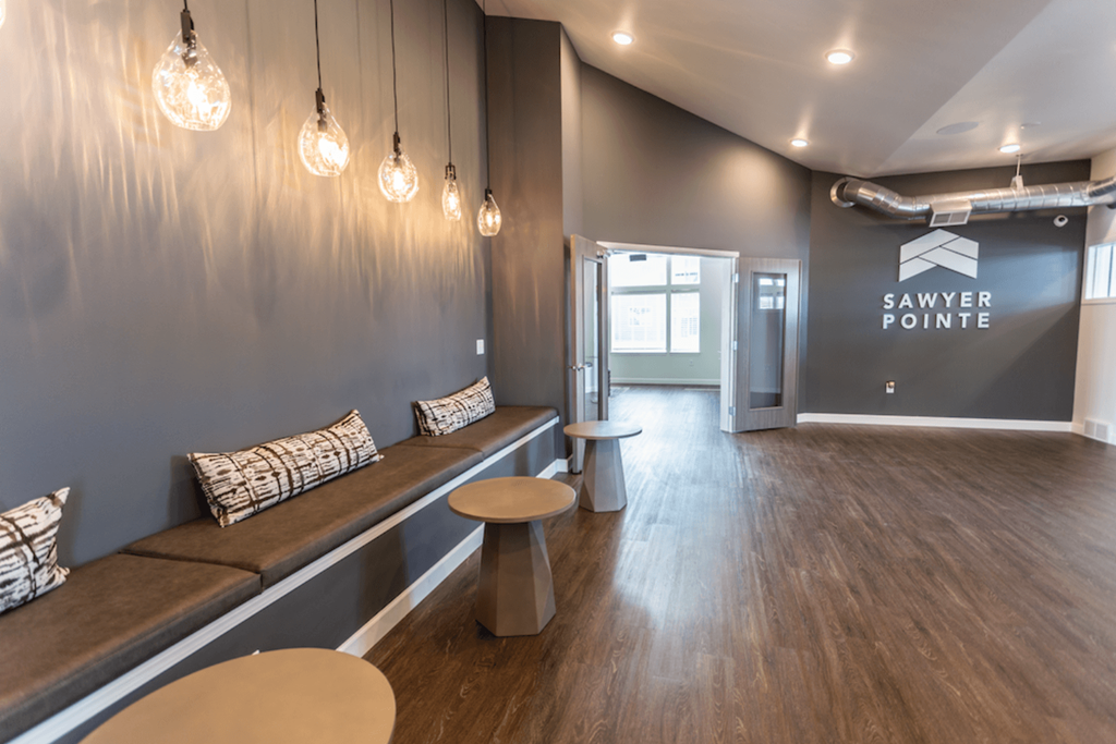 A room with a bench and a table in it.