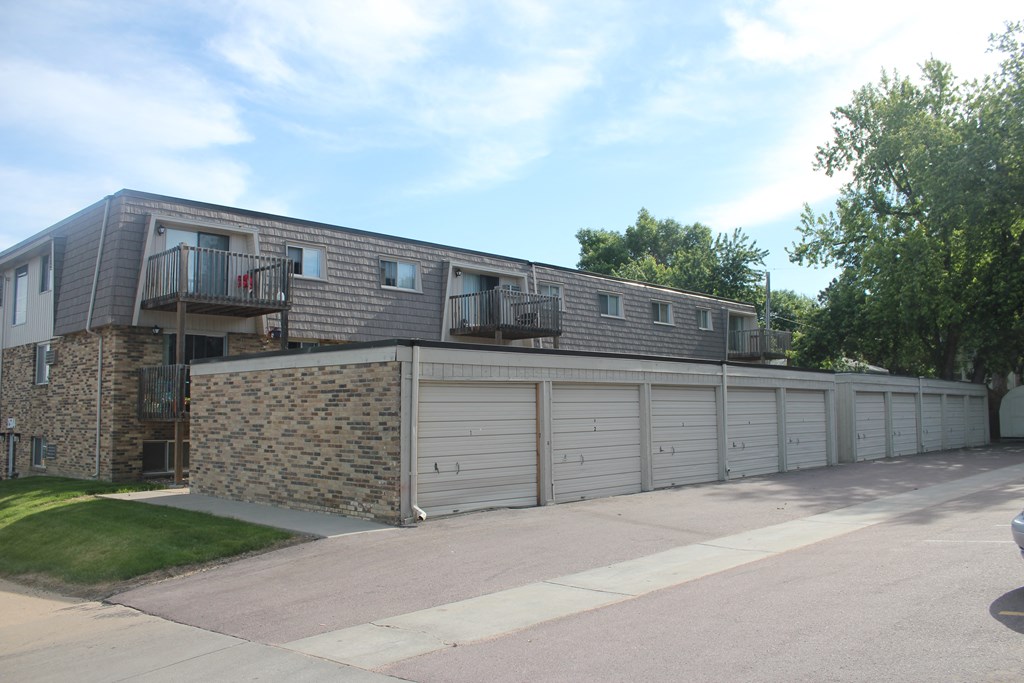 the front of an apartment building with a garage