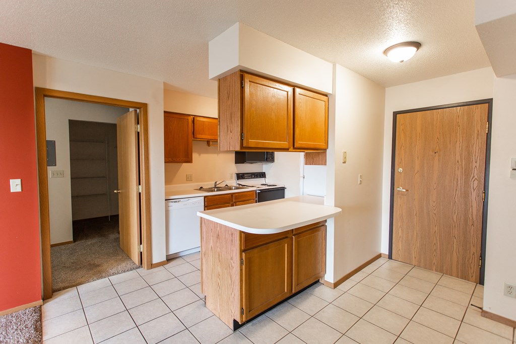 an empty kitchen with an island in the middle