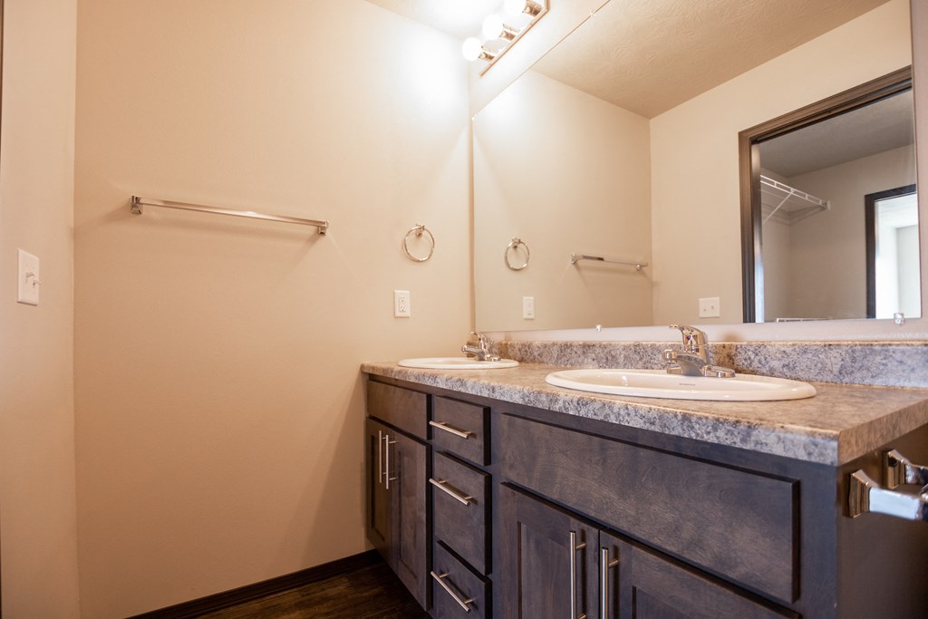an empty bathroom with a sink and a mirror