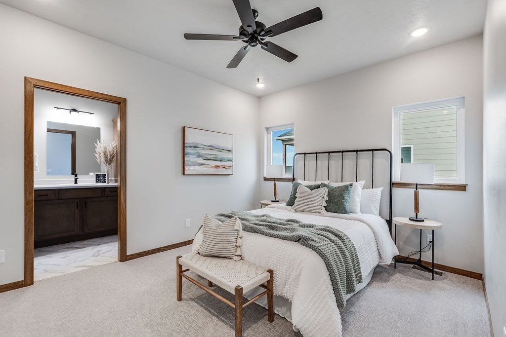 a bedroom with a bed and a ceiling fan