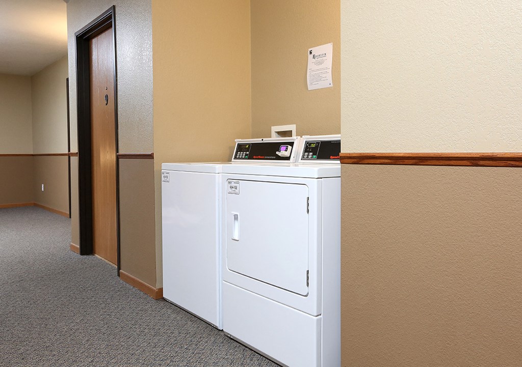a washer and dryer in a room with a door