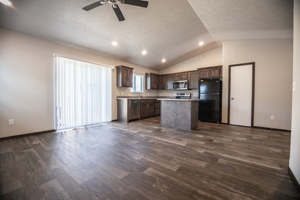 the view of a living room and kitchen with a sliding glass door
