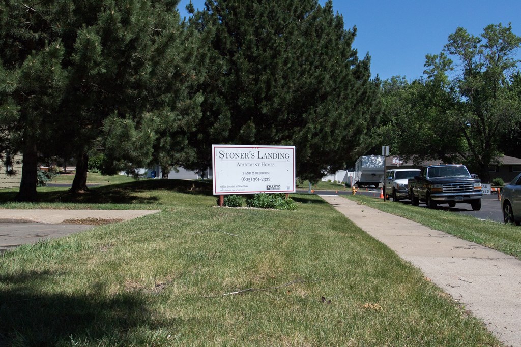 a sign sitting on the side of a sidewalk