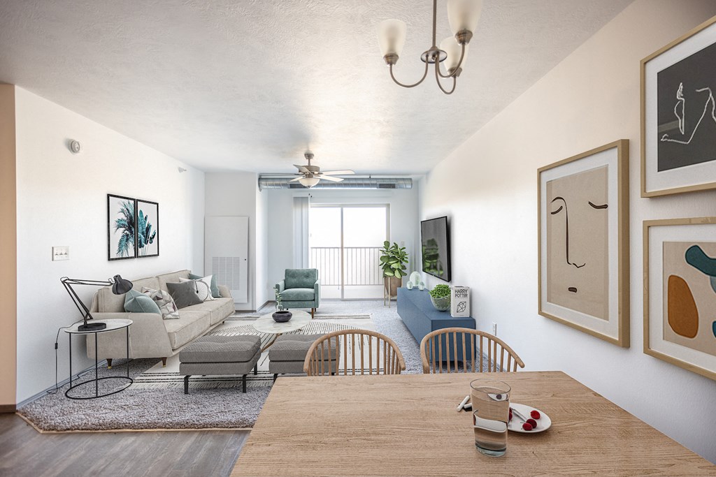 a living room and dining room with a table and a couch