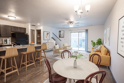 A modern living room with a white dining table and chairs.