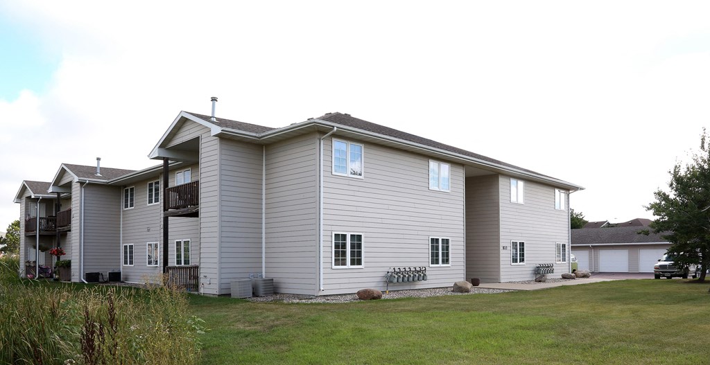 a white house with a yard in front of it