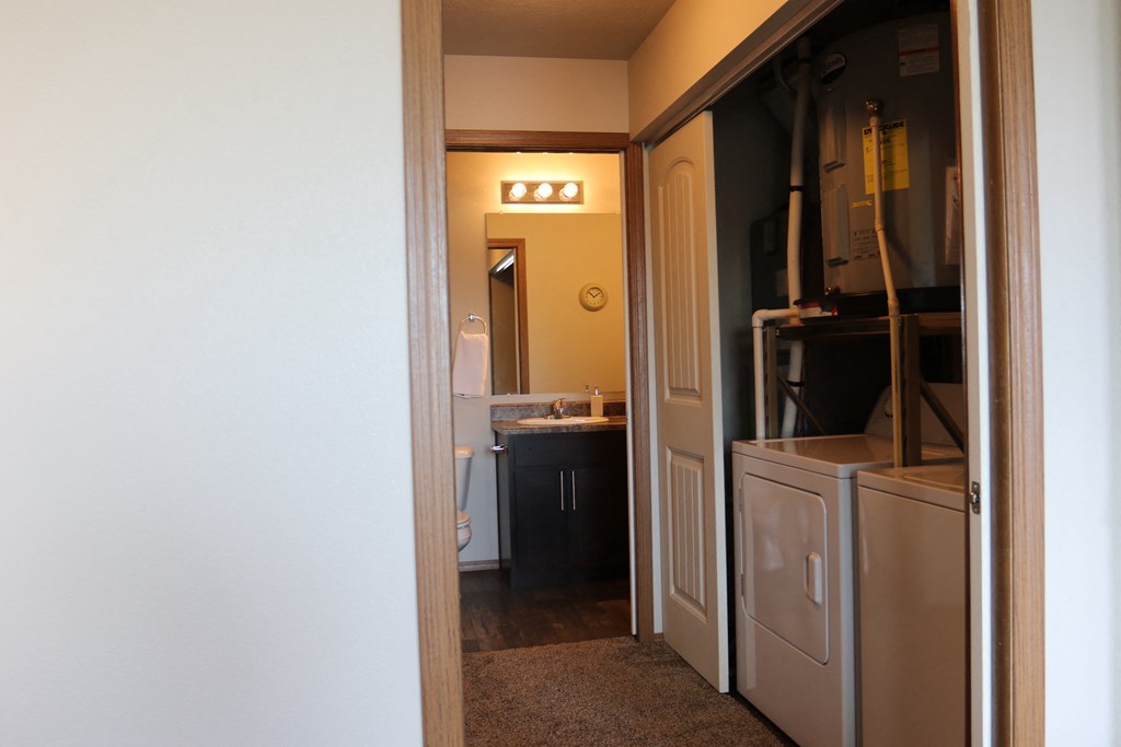 a view through a door into a bathroom with a sink and a mirror