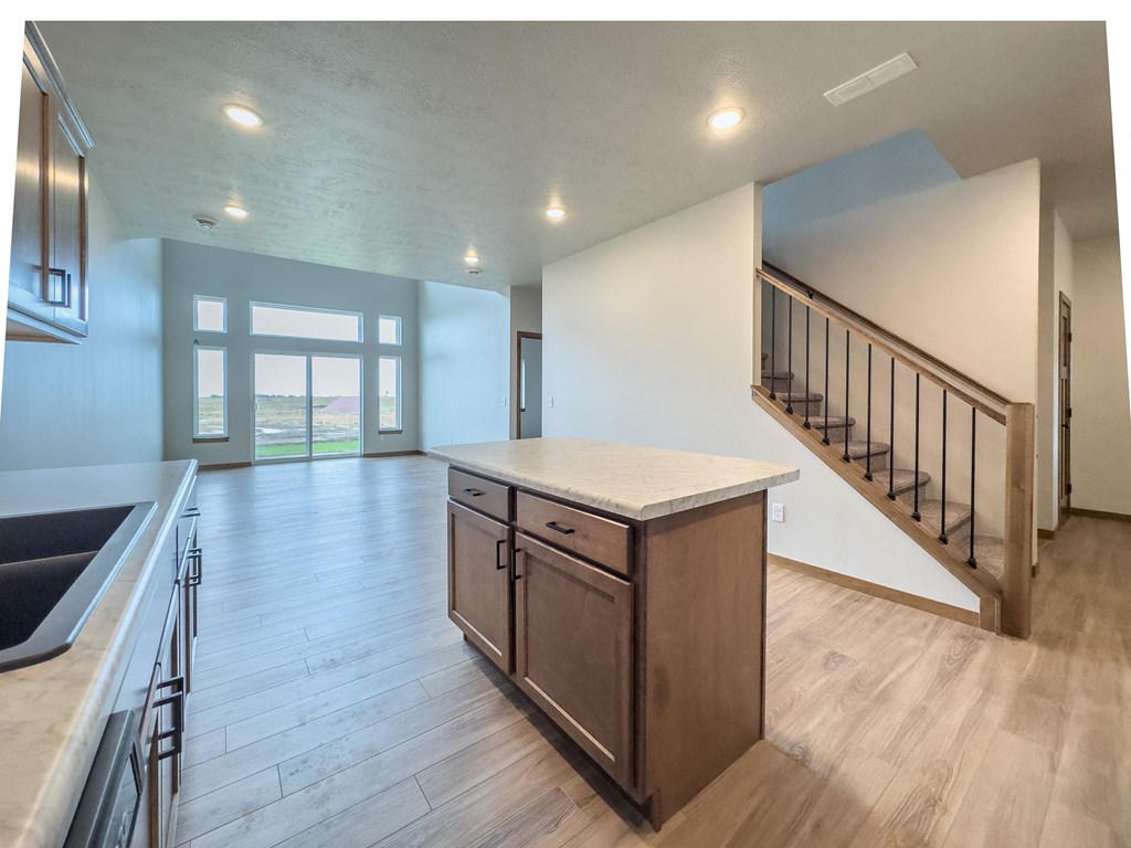 the kitchen is open to the living room and staircase to the second floor